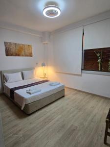 a bedroom with a large bed and a window at Maryland Lodge hideaway in Kakopetria