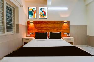 Postel nebo postele na pokoji v ubytování Collection O Karyavattom Near Green Field Stadium + 19 fotografií