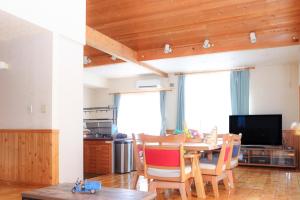 a kitchen and dining room with a table and chairs at Flower House Toya in Lake Toya