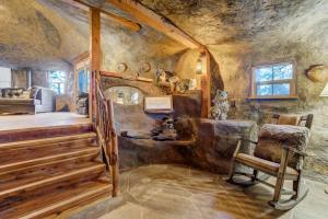 a room with a bed and a chair in a room at Cave Cabin Hot Tub Fire Pit MTN Experience in Florissant