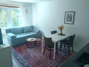 a living room with a couch and a table at Herzstück Simonskall in Hürtgenwald +27 photos
