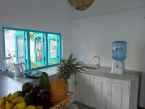 a kitchen with a bowl of fruit on a counter at Amma's Garden in Unawatuna