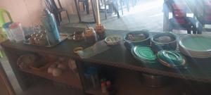 a counter top with bowls and plates on it at Pangong Destination in Spangmik