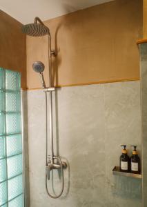 a shower with a shower head in a bathroom at Salty Pearl Phuket 1 in Patong Beach