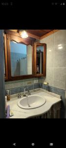 a bathroom with a sink and a mirror at Pao Pei in Santa Rosa de Calamuchita