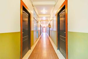 a hallway with two doors and a long corridor at Collection O Tapovan Near Deacon Valley in Rishīkesh