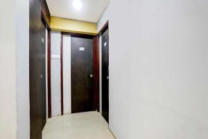 a corridor with two doors in a building at Collection O Wardha Road Near Airport in Nagpur