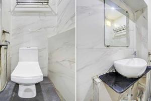 a white bathroom with a toilet and a sink at Collection O Wardha Road Near Airport in Nagpur