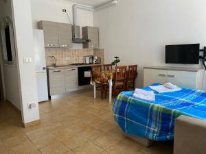 a kitchen with a table with a blue blanket on it at Casa Giulia near Lazise, Garda lake and Gardaland in Lazise