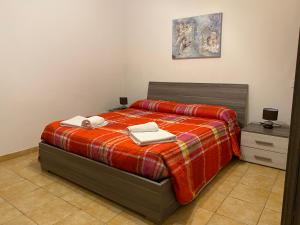 a bedroom with a bed with two towels on it at Casa Giulia near Lazise, Garda lake and Gardaland in Lazise