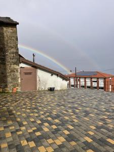 a rainbow in the sky over a building at Borgo dell'Anello in Castiglione dei Pepoli