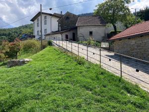a fence in a field next to a house at Borgo dell'Anello in Castiglione dei Pepoli