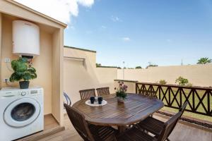 a balcony with a table and a washing machine at Casa Tagoro Dream in Costa Del Silencio