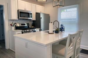 a kitchen with a white counter top and a refrigerator at Cozy Campbell Bungalow in Columbus