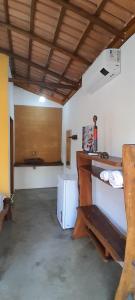 a room with a white refrigerator and a table at Chalés Santo Verde 2 in Goiás