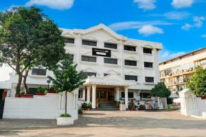 a white building with a sign in front of it at Townhouse Oak Jaipur Arya Square Shopping Mall in Jaipur +17 photos