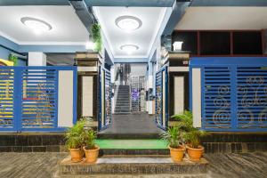 un bâtiment avec des portes bleues et des plantes en pot dans l'établissement Collection O Ardha Nareeshwar Temple Kothaguda, à Hyderabad