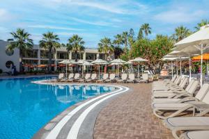 a swimming pool with lounge chairs and umbrellas at VONRESORT Golden Beach & Aqua - Kids Concept-Ultra All Inclusive in Side