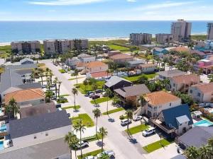 an aerial view of a city with the ocean at Beach & Palms condo condo in South Padre Island