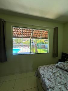 Postel nebo postele na pokoji v ubytování Casa de praia no condomínio verdes mares km 17 + 27 fotografií