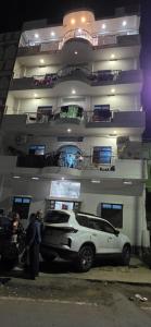 a white car parked in front of a building at Shahi House in Bodh Gaya