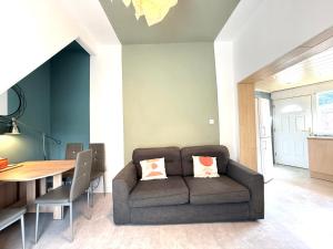 a living room with a couch and a table at Bee Stays - Cooper House in Haydock