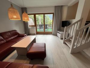 a living room with a couch and a table at Schlossalm Appartement in Bad Hofgastein