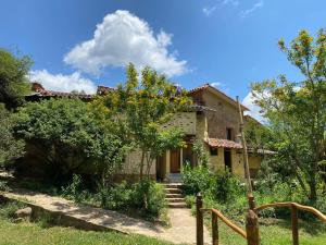 an old house with a garden in front of it at El Jardin in Samaipata