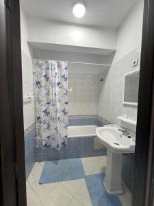 a bathroom with a sink and a toilet and a shower at corniche de Malabata in Tangier +7 photos