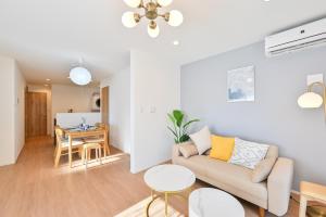 a living room with a couch and a table at Hotel Tsunagari 2 in Fukuoka