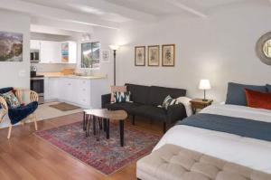 a bedroom with a bed and a living room at Heart of Sedona Hideaway in the Desert in Sedona +17 photos