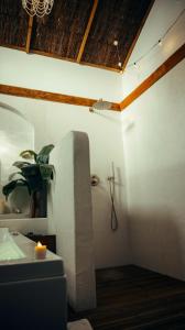 a bathroom with a sink and a toilet in a room at Love room Piccola casa, côté île in La Verpillière