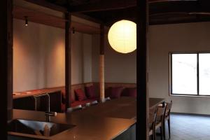 a dining room with a table and chairs and a light at suo Camellia Island Inn - Vacation STAY 95452v in Oshima +17 photos