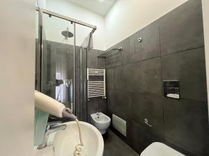 a bathroom with a sink and a toilet at Nereides Guest House in Naples