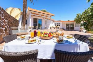 a table with a bowl of fruit on a patio at Parralito by VillaGranCanaria in Ingenio +35 photos