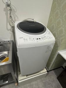 a washing machine sitting on a shelf in a room at 依茶宿 in Matsudo +14 photos