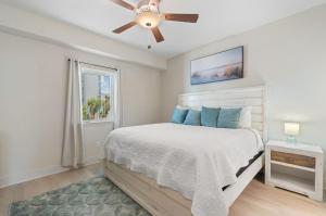 a bedroom with a bed with a ceiling fan at Sea Glass Unit 209 in Gulf Shores