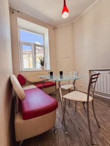 a room with a table and chairs and a window at Kyiv Sofia Apartment in Kyiv +14 photos
