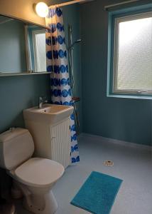 a bathroom with a toilet and a sink and a window at Centrally located holiday home in Stöllet in Stöllet