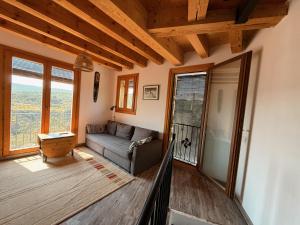 a living room with a couch and some windows at Casa rural Serafin in Murillo de Gállego