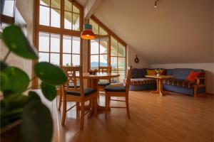 a living room with a table and chairs and a couch at Ferienhof Sinz im Allgäu in Weiler-Simmerberg