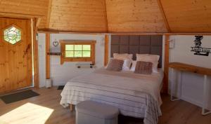 a bedroom with a bed in a wooden room at Lovely Kotas in Brettnach