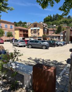 a parking lot with a bunch of cars parked at Vivic Home Monforte in Monforte dʼAlba
