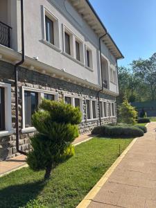 a building with a tree in front of it at Villa Irina - Veliko Tarnovo in Veliko Tŭrnovo