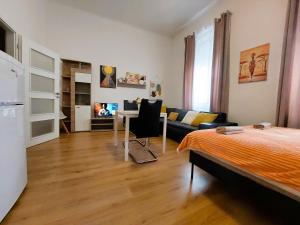 a bedroom with a bed and a living room at Apartment ČSA #4 in the Historic Center Hradec Králové in Hradec Králové