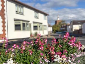 a group of flowers in front of a house at 4 Bed Home In Central Maldon in Maldon
