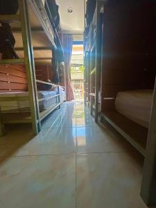 a room with two bunk beds and a hallway at Tnon Samui Hostel in Chaweng