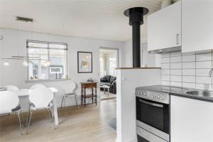 a kitchen and living room with a stove top oven at N088-Karrebaeksminde-Baekkene-201-B in Karrebæksminde
