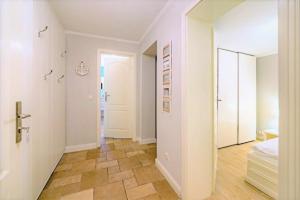 a hallway with a bed and a mirror at Strandgut EG in Morsum +13 photos