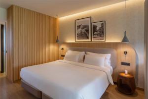 a large white bed in a hotel room at Radisson Resort & Residences Tenerife - Adults Only in Puerto de la Cruz